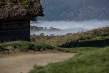 Autumn countryside landscape with wooden houses, thatched roof during sunriseの写真素材