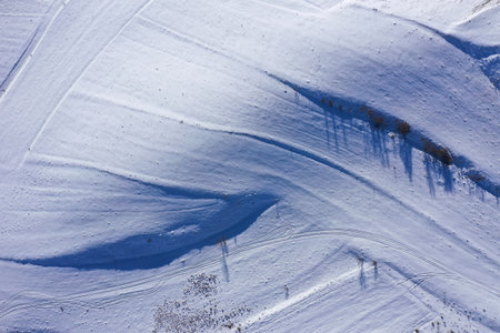 Aerial drone view of snow patterns and background. Snow covered countryside in the mountainsの写真素材