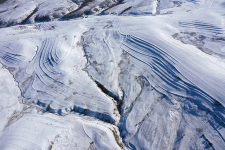 Aerial drone view of snow covered countryside terraces in the mountainsの写真素材