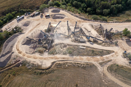 Aerial view of stone quarry conveyor belt system in operation, stone jaw crusher plant