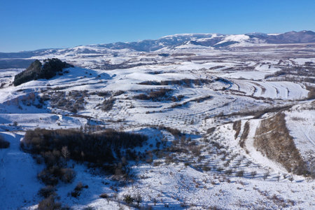 Aerial drone view of snow covered countryside hills and meadowの写真素材
