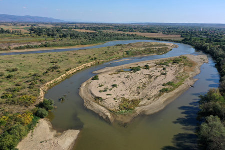 Aerial view of a huge sand riverbank island on a river by droneの写真素材