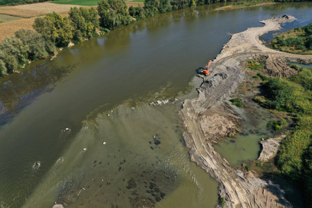 Sand and gravel extraction in the river aerial view by drone
