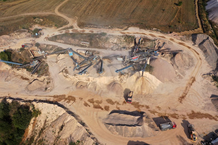 Aerial view of stone jaw crusher plant. Sand making plant and belt conveyor in mining quarry. Sand crushing and bulk materials for constructionの写真素材