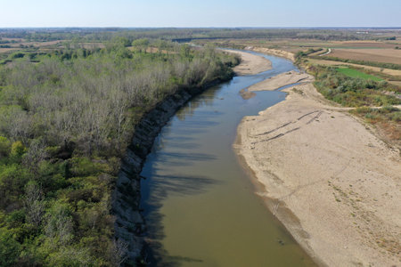 Flying over a river flowing on a plain aerial view by droneの写真素材