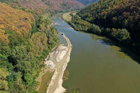 Sand and gravel extraction in the river aerial view by drone