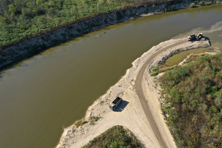 Sand and gravel extraction in the river aerial view by droneの写真素材