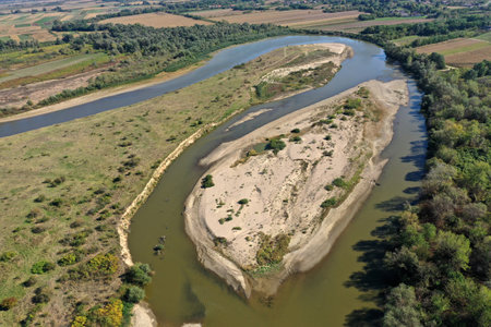 Aerial view of a huge sand riverbank island on a river by droneの写真素材