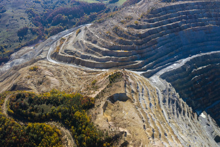 Flying above an open pit mine, copper excavation in Rosia Poieni, Romania. Aerial drone viewの写真素材