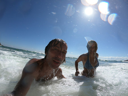 Sea waves splashing on happy couple. Just married conceptの写真素材