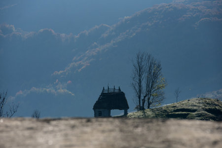 Mountain homestead in the autumn. Countryside thatched roof houses, barn, lodge. Transylvania, Romaniaの写真素材