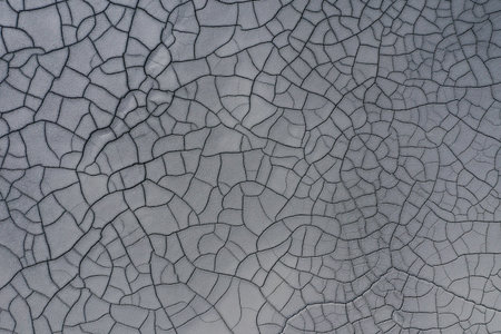 Aerial view of gray abstract mud patterns and cracks on acid mine drainage surface by drone