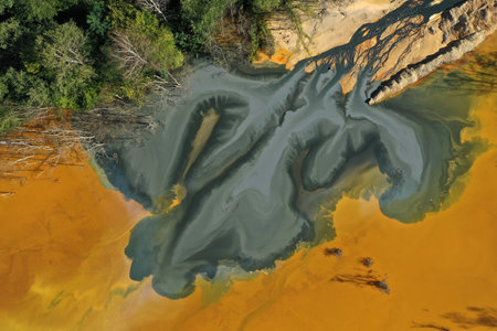 Flying over patterns of acid mine drainage in decanting lake aerialの写真素材