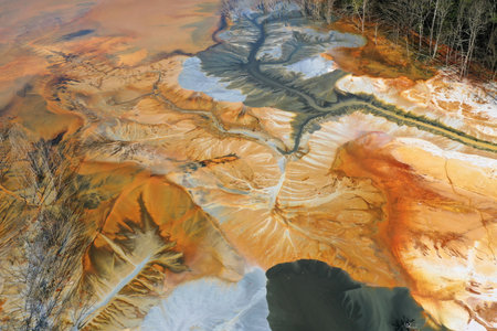 Abstract natural colorful patterns of acid mine drainage in decanting lake aerial view by droneの写真素材