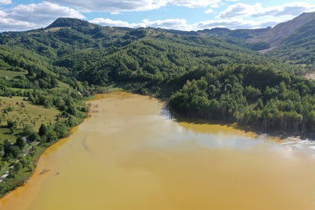Patterns of acid mine drainage in decanting lake, nature pollution, aerial view by droneの写真素材