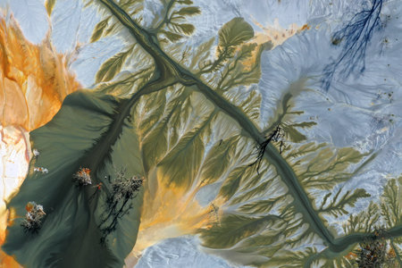 Patterns of acid mine drainage in decanting lake, nature pollution, aerial view by droneの写真素材