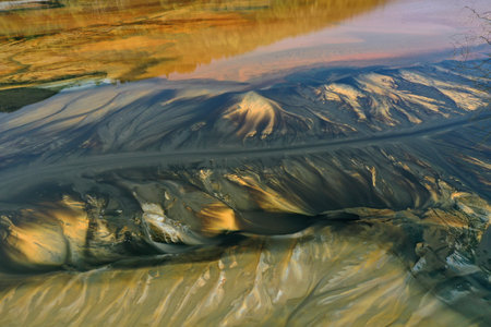 Aerial view of acid mine water drainage flow, toxic mine waters polluting the environment. Rosia Montana, Romania by droneの写真素材