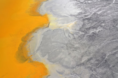 Aerial view of acid mine water drainage flow, toxic mine waters polluting the environment. Rosia Montana, Romania by droneの写真素材