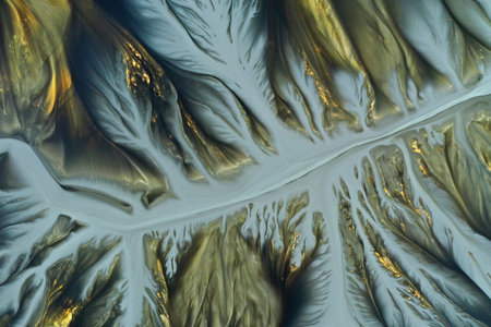 Aerial view of surreal natural patterns flowing into a decanting lake by droneの写真素材