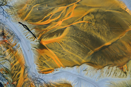 Aerial view of acid mine water drainage flow, toxic mine waters polluting the environment. Rosia...