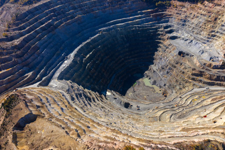 Flying above an open pit mine, copper excavation in Rosia Poieni, Romania. Aerial drone view