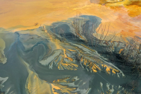 Aerial view of colorful contaminated cyanide residuals waters from gold mine. Abstract nature...