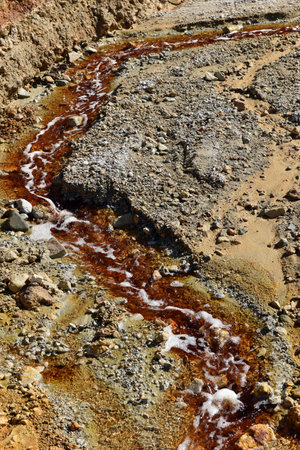 Toxic gold mining residual waters from gold mine flowing and polluting environment. Rosia Montana, Romaniaの写真素材