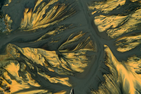 Flying over surreal patterns of flowing colorful mining chemical residuals aerial by droneの写真素材