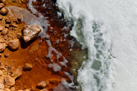 Toxic gold mining residual waters from gold mine flowing and polluting environment. Rosia Montana, Romaniaの写真素材