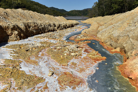 Toxic gold mining residual waters from gold mine flowing and polluting environment. Rosia Montana,...