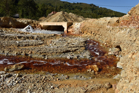 Toxic gold mining residual waters from gold mine flowing and polluting environment. Rosia Montana, Romaniaの写真素材