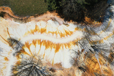 Aerial view of surreal natural patterns of gold cyanide leaching flowing into decanting lake by droneの写真素材