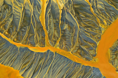 Aerial view of surreal toxic water stream from copper mine in decanting lake. Natural pattern by...