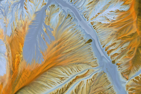 Aerial abstract surreal natural patterns above. Colorful chemical mining leach residues in decanting...