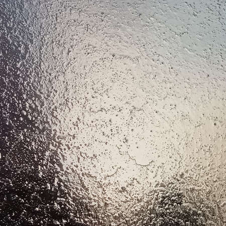 Frost on the windshield, the rays of the morning sun melt the frost formed overnight. Background, texture.の写真素材