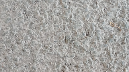 Pebbles, Crushed stone in the cement yard. Dirty cracked old grunge vintage light gray concrete and old cement texture.の写真素材