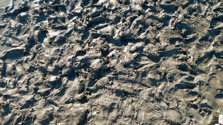 Footprint or imprint shoe in the mud.Mud texture or wet brown soil as natural organic clay and...