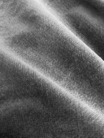 Close-up of gray denim fabric texture. Seamless background of cotton material with a detailed...