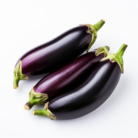 A colorful image featuring three shiny eggplants on a clean white background. Great for healthy eating themes, vegetarian recipes, and food-related content for blogs and marketing.の素材