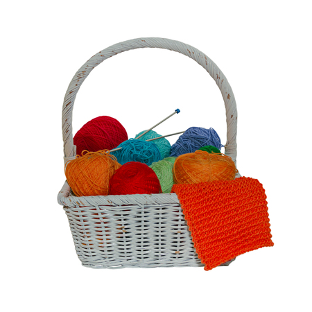 Wool basket with knitting needles isolated on backgroundの写真素材