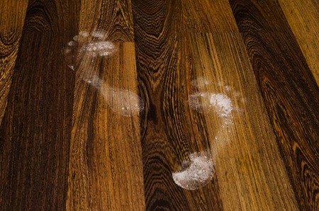 Foot prints on the tiled floor, construction siteの写真素材