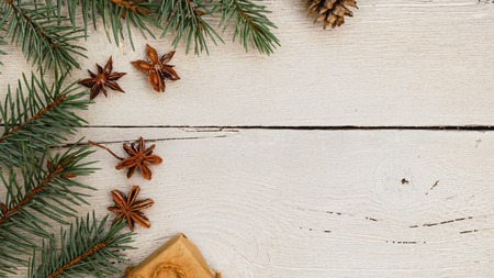 Christmas gifts, fir tree branches on white wooden table, background. Christmas composition. Flat lay, frameの写真素材