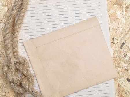 Vintage paper and rope on old wooden boardsの写真素材