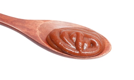 tomato sauce in the spoons isolated on white background
