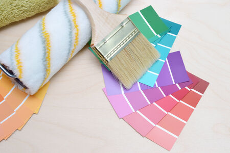color palette and brush on a wooden background.