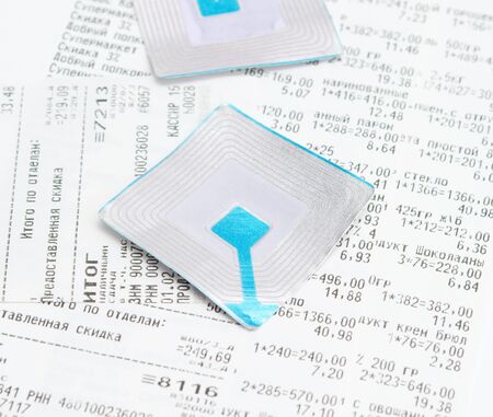 wireless tag on pile  of generic grocery receipts with costs shown