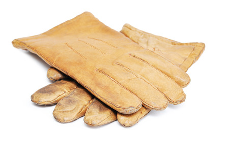 Old dirty leather gloves Isolated on whiteの写真素材