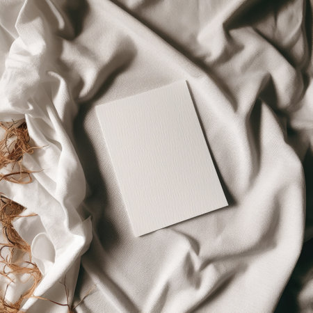 Blank business card on white fabric. Mockup for branding identity.の素材