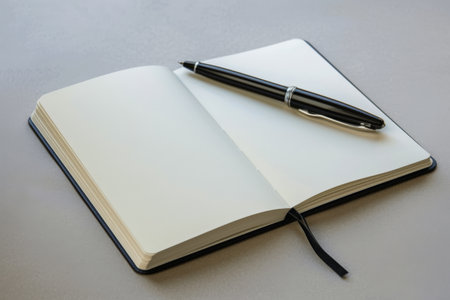 notebook and pen on a white background, business and office conceptの素材