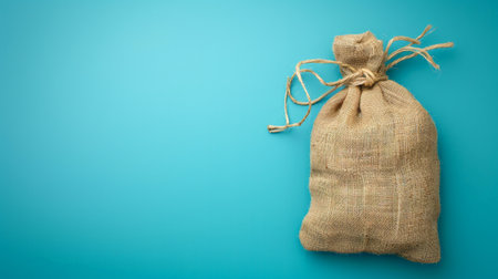Bag of burlap on a blue background with space for textの素材